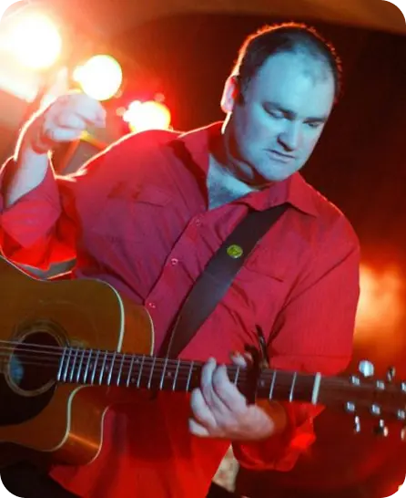 performer playing guitar on stage